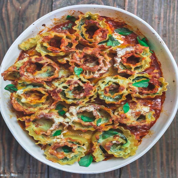 A big serving platter filled with cheesy zucchini lasagna roll-ups.