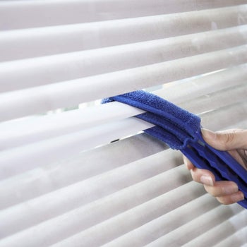 cleaner being used on blinds