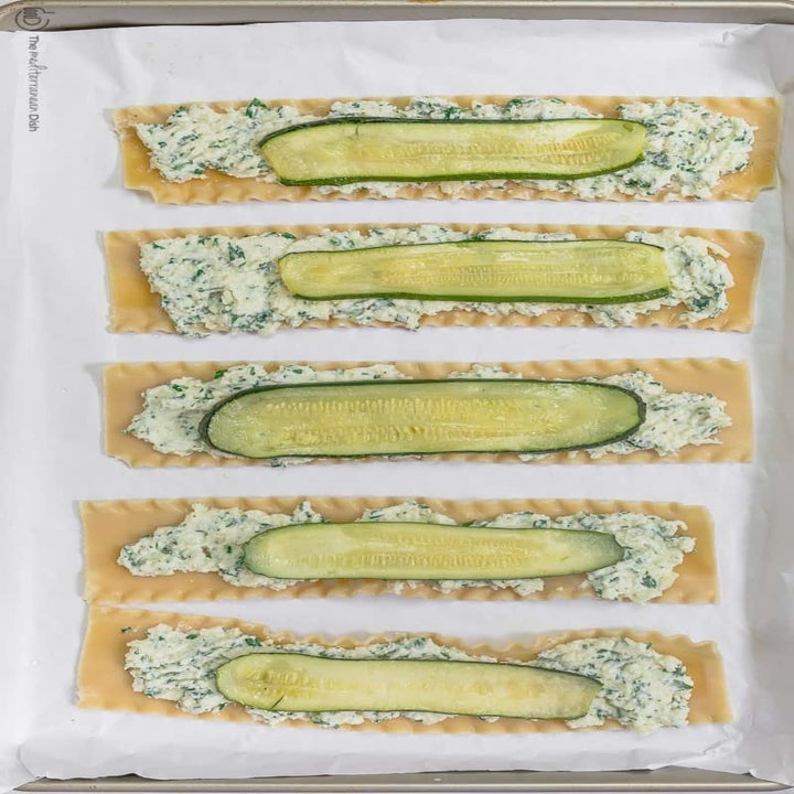 Lasagna noodles covered with a ricotta cheese mixture and thin ribbons of zucchini.