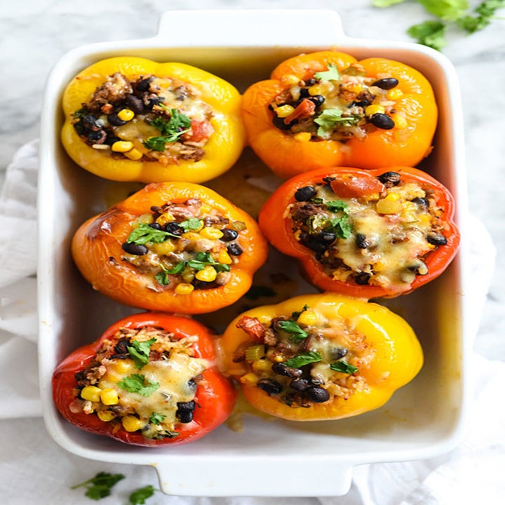 Six stuffed peppers filled with sausage, beans, corn, and more.