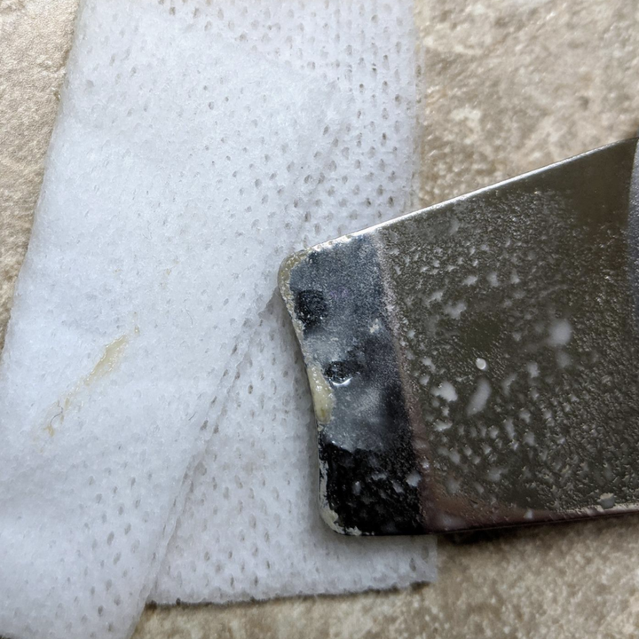 Reviewer image of a closeup of the spatula showing tons of gunk and dirt that was removed from face
