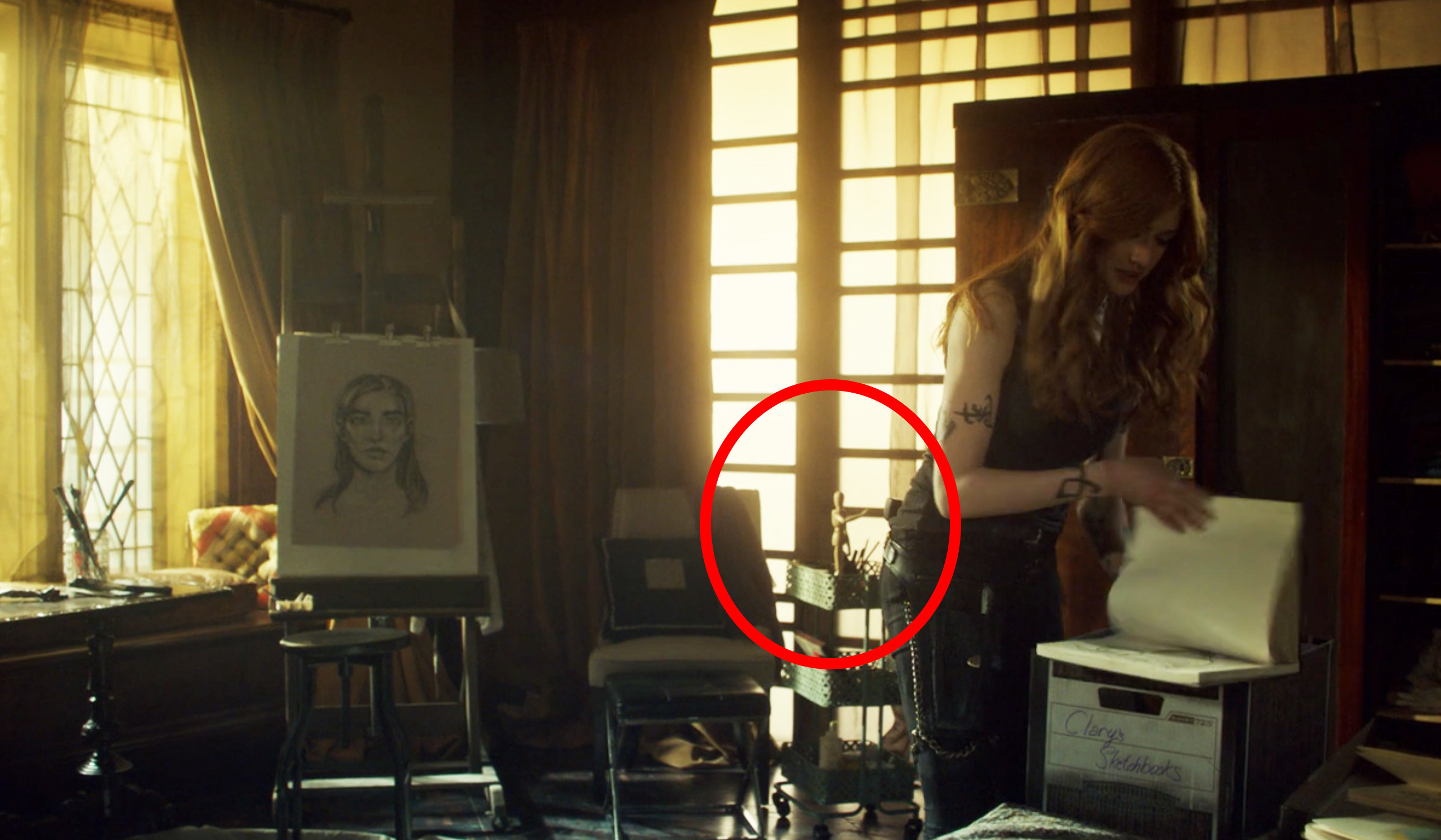 A circle pointing to Clary&#x27;s artist mannequin in her bedroom