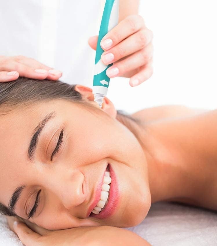 A person using the ear-cleaning tool 