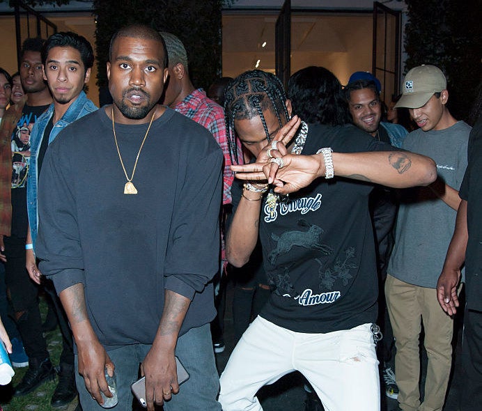 Kanye West and Travis Scott pose at an industry event