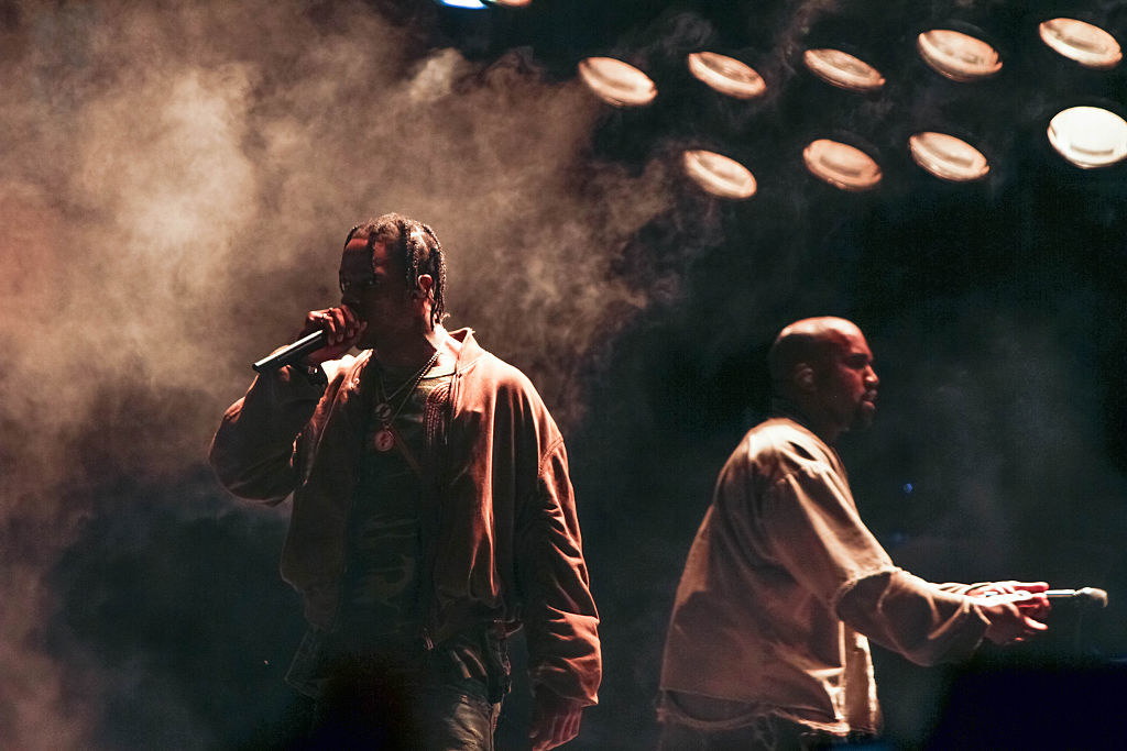 Travis Scott and Kanye West performing together on-stage at a concert