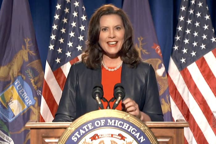 Governor Gretchen Whitmer stands behind a lectern with a "state of Michigan" seal on it