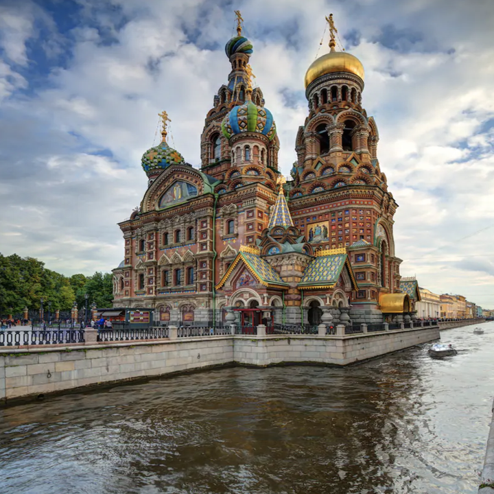 A shot of the Church of the Savior of Spilled Blood with colorful pastel walls and golden tops on its towers