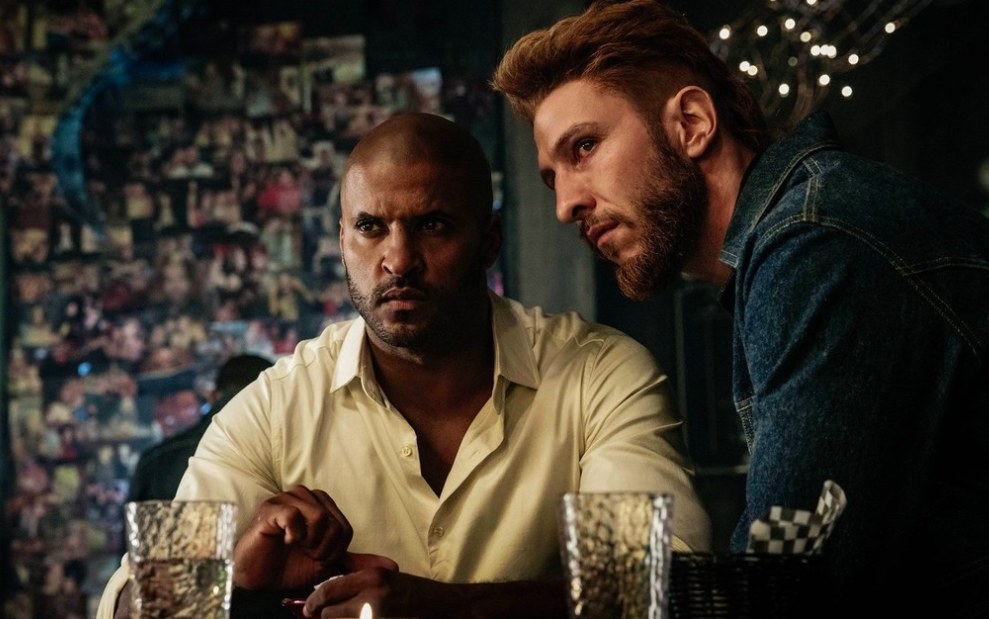 American Gods still: Shadow Moon and Mad Sweeney sit together in a bar