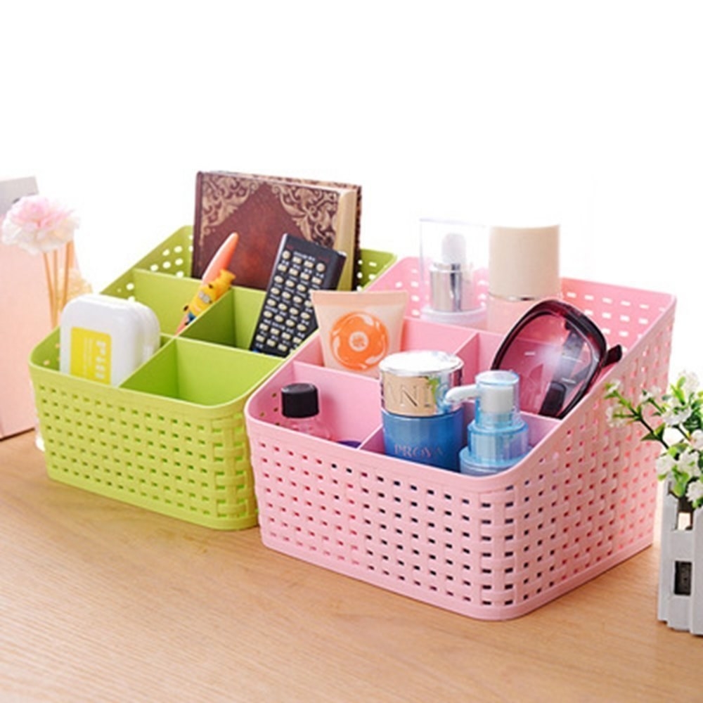 A green and pink organiser with miscellaneous items in it.