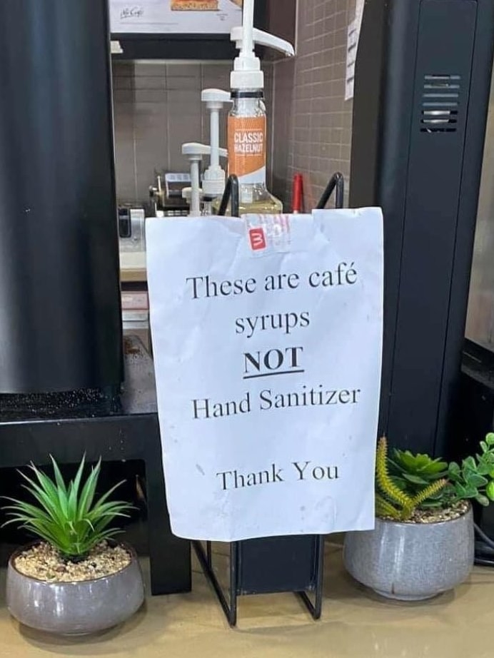 sign reading these are cafe syrups not hand sanitizer thank you