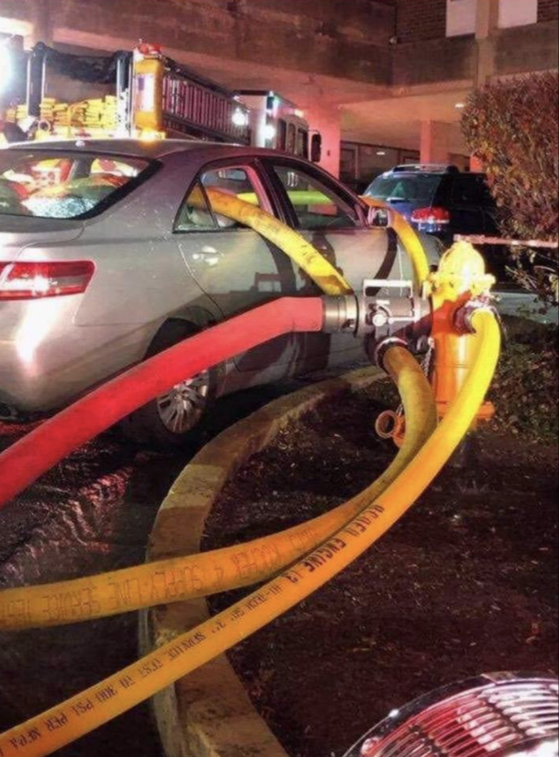 a bunch of tubes through a car next to a fire hydrant