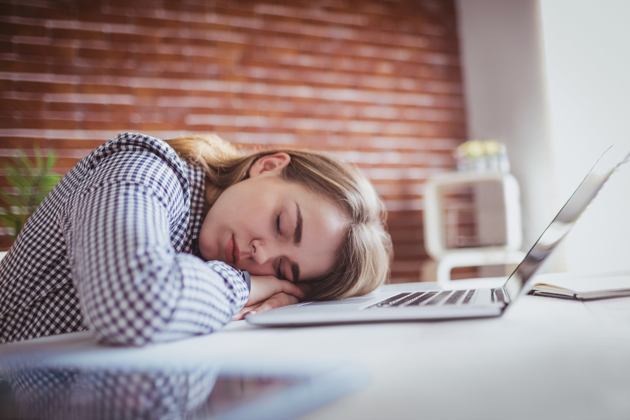 A student takes a short nap at their desk