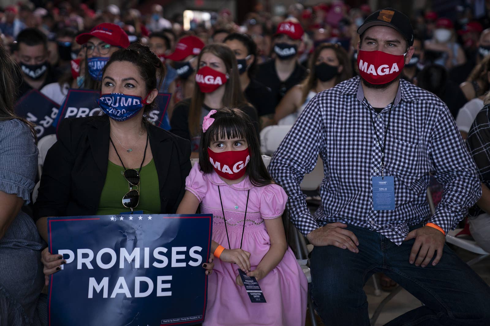 A crowd wearing MAGA masks