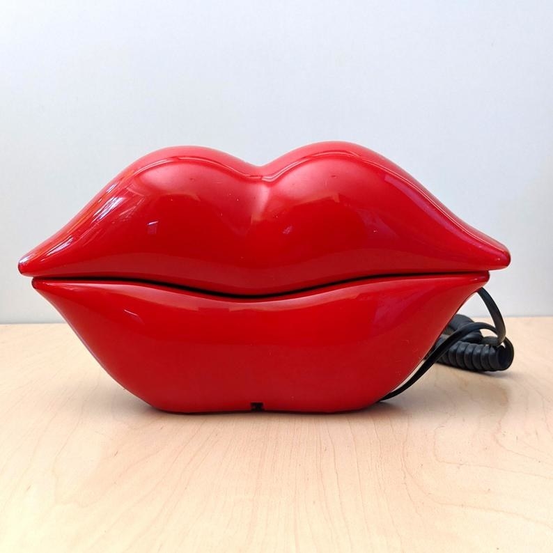 A landline phone in the shape of lips in red.