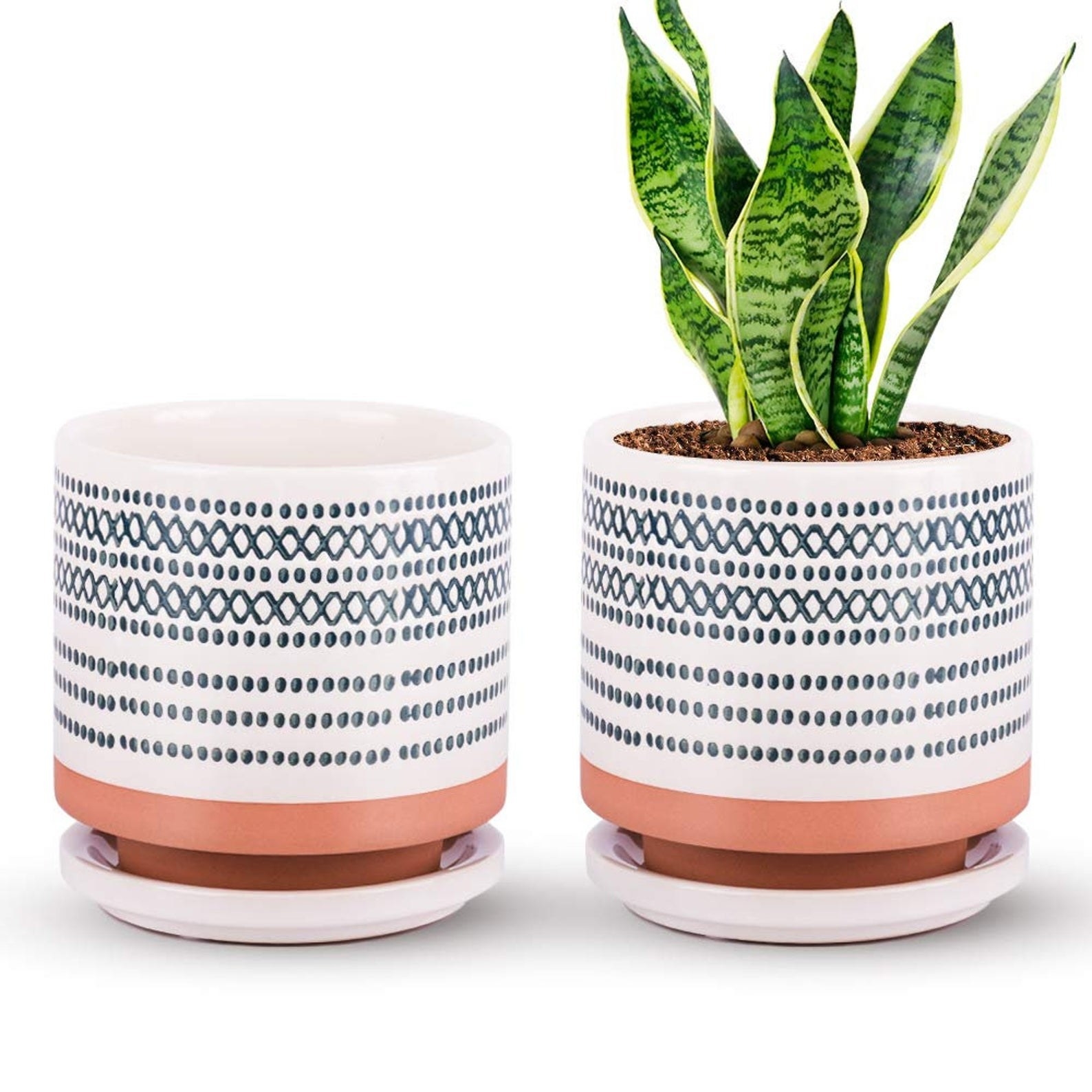 Two white pots with dark blue designs on them