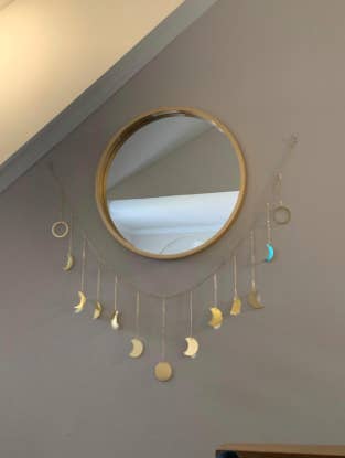 reviewer pic of garland hung up underneath a round mirror
