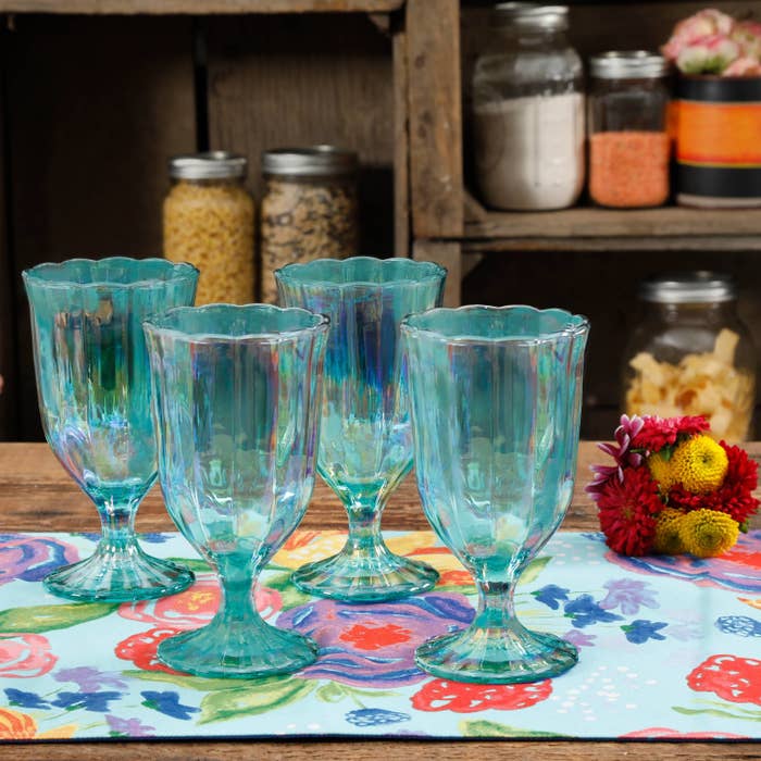 set of four green goblets on a table