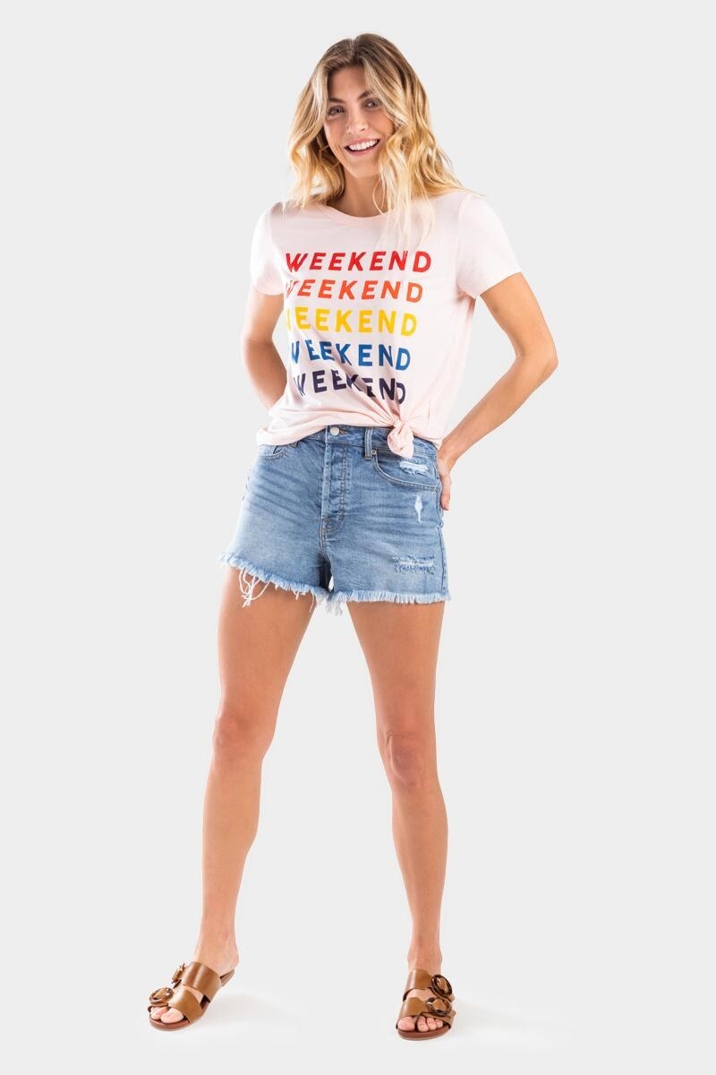 a model in a pink that says &quot;weekend&quot; on it five times in different colors