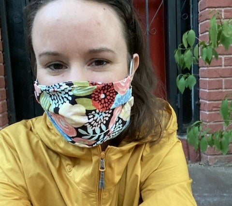 Davis wears a mask with a floral print