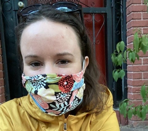 Davis wears a mask with a floral print