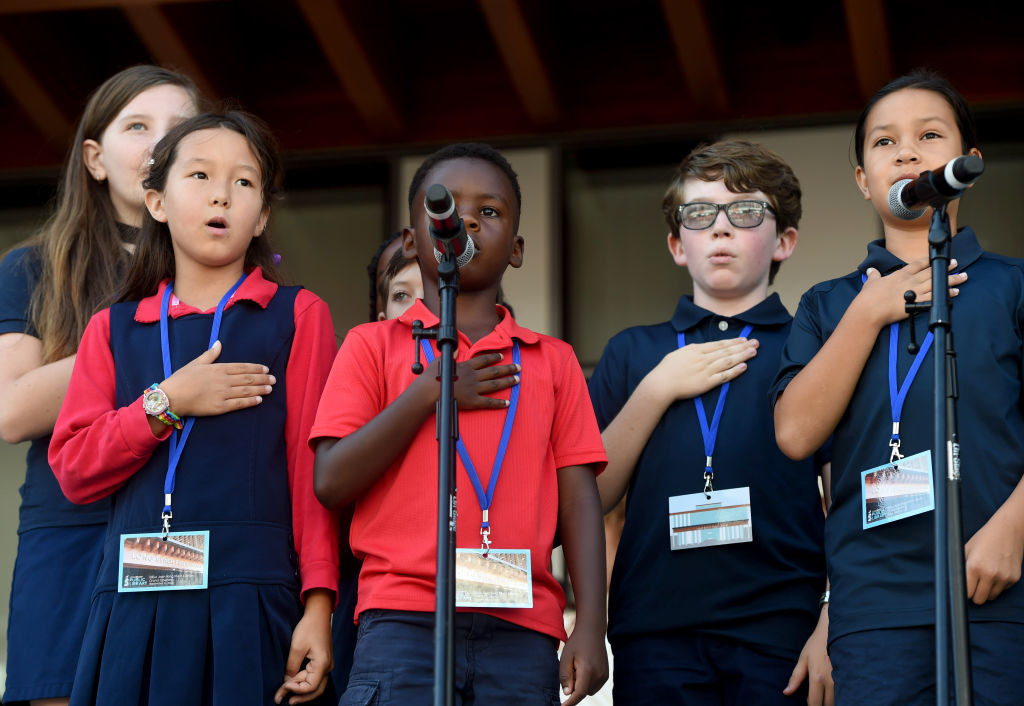 Elementary school students doing the Pledge of Allegiance