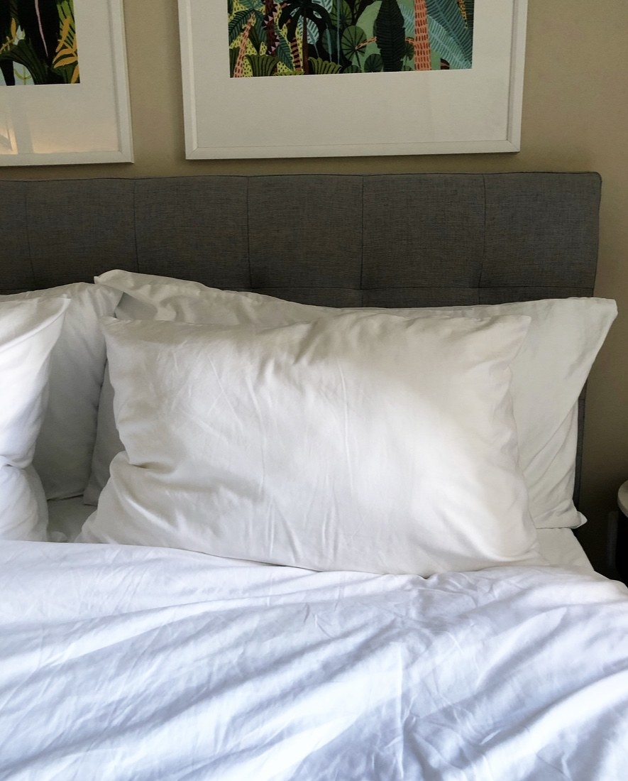 White pillows displayed on a bed.