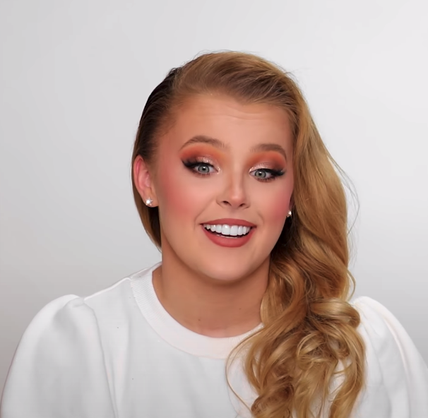 JoJo Siwa in a glam makeup look, with glittered eyeshadow on her lids