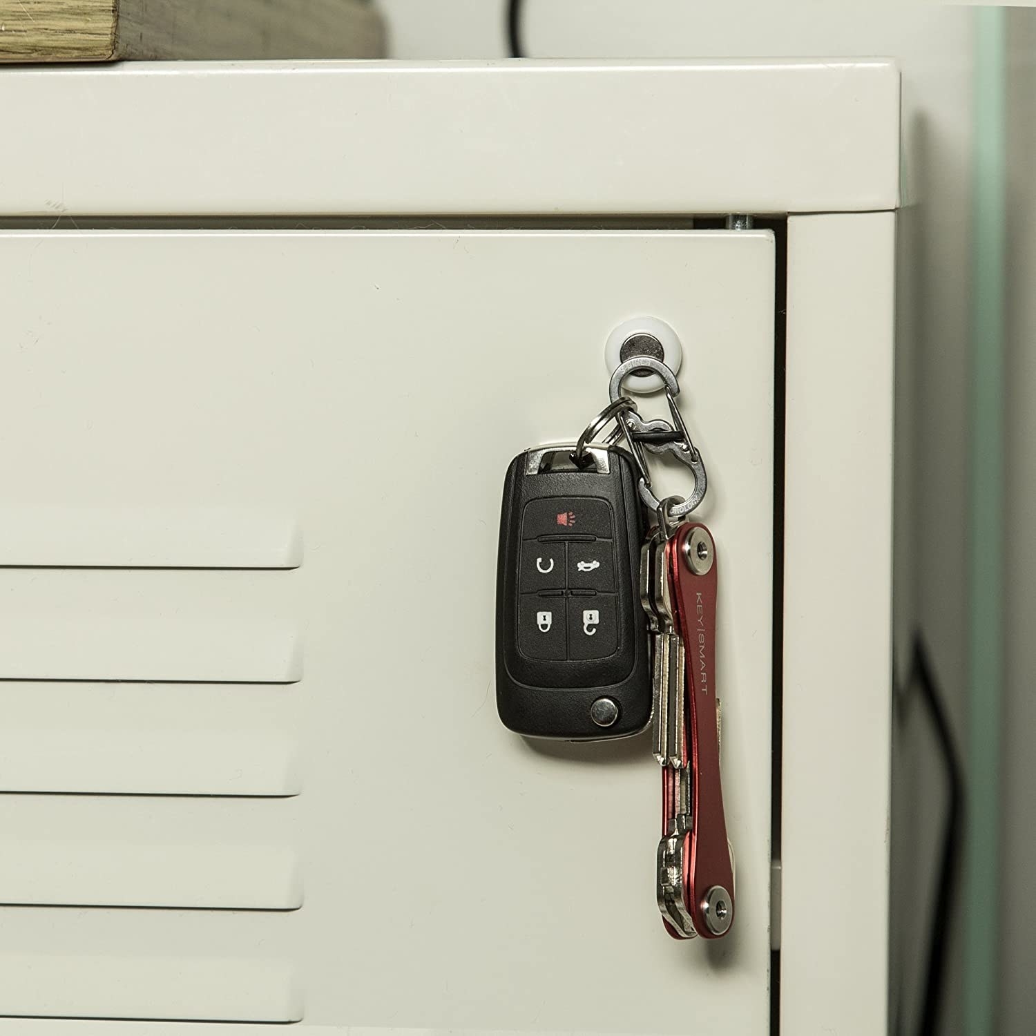 A magnetic key sticker holding a keyring filled with keys