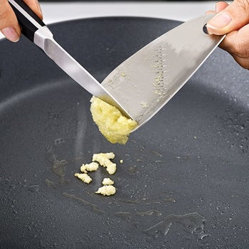 model scraping garlic from silver grater 