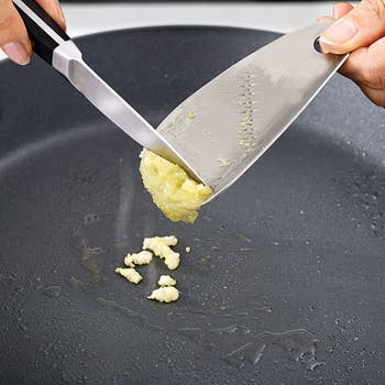 model scraping garlic from silver grater 