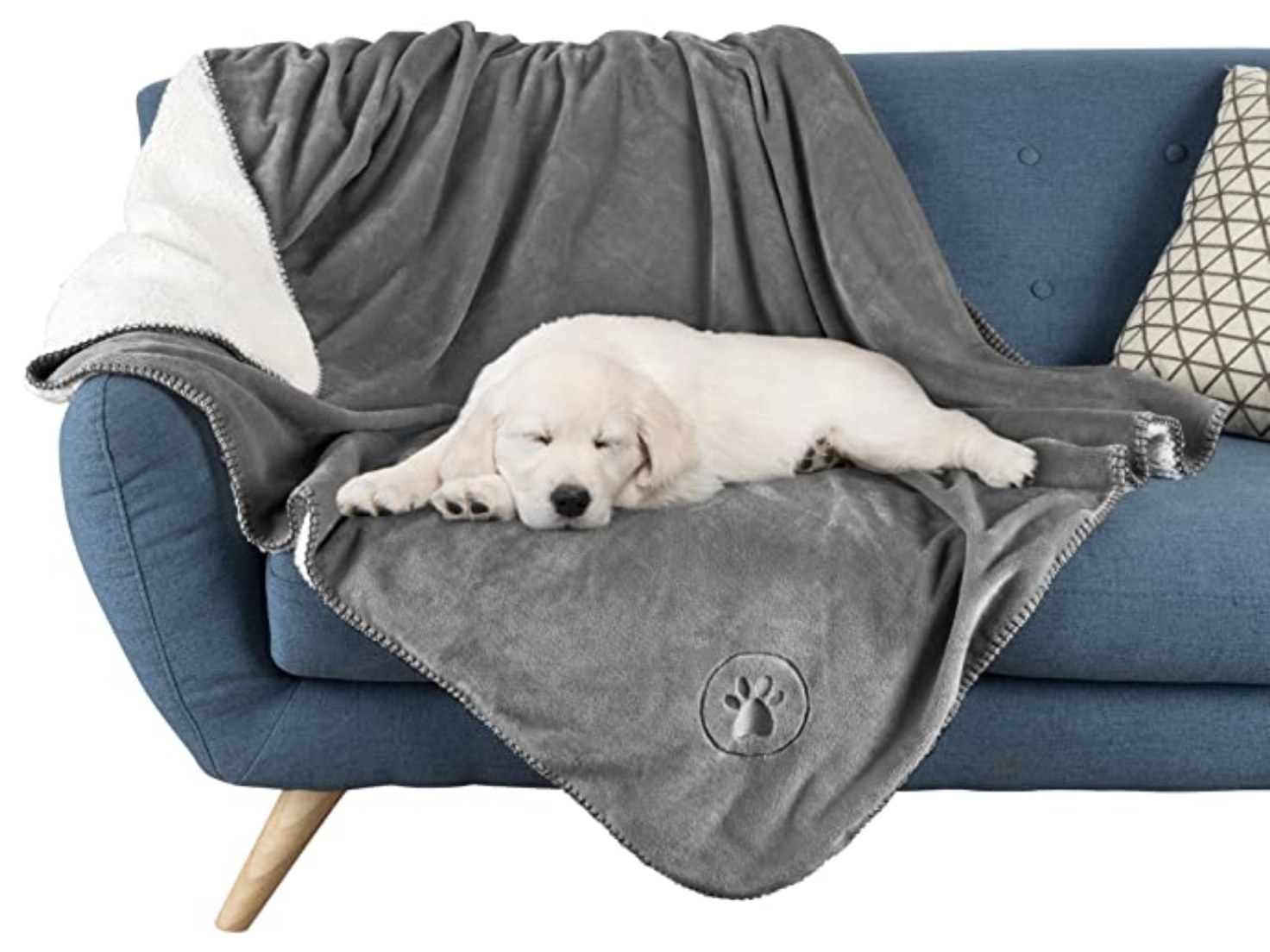 A yellow lab puppy sleeping on a grey waterproof pet blanket