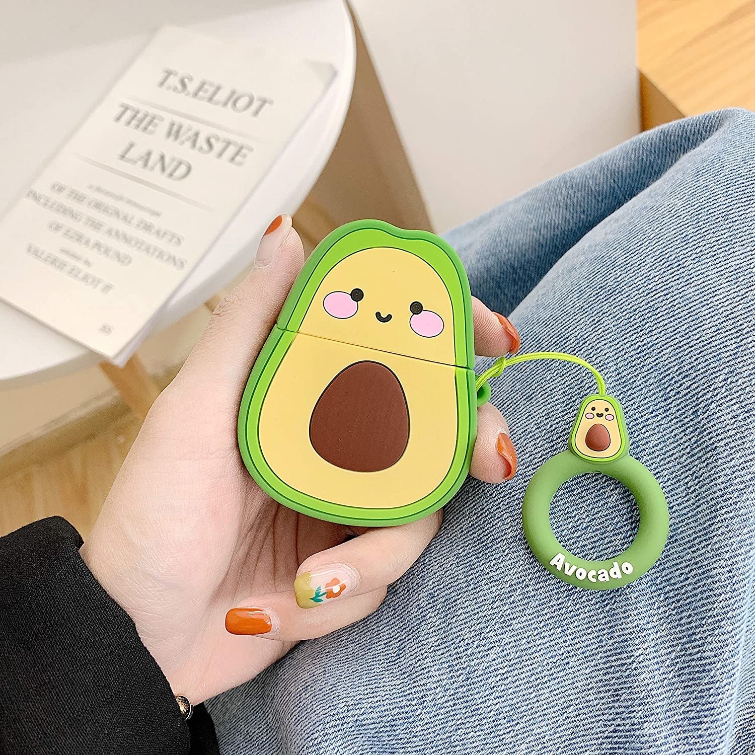 A person holding the avocado earbud case