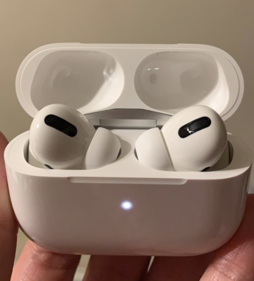a reviewer&#x27;s photo of the airpod pros in their charging case