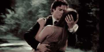 Damon bending Elena down in a dance as he holds her head