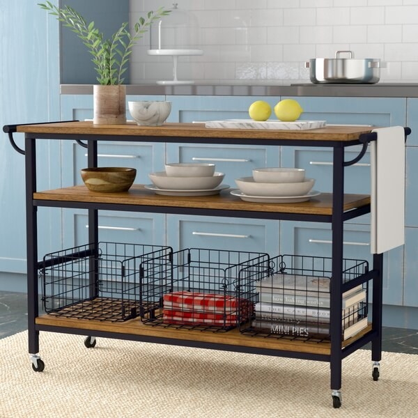 Long three shelf kitchen island with wheels and included wire baskets