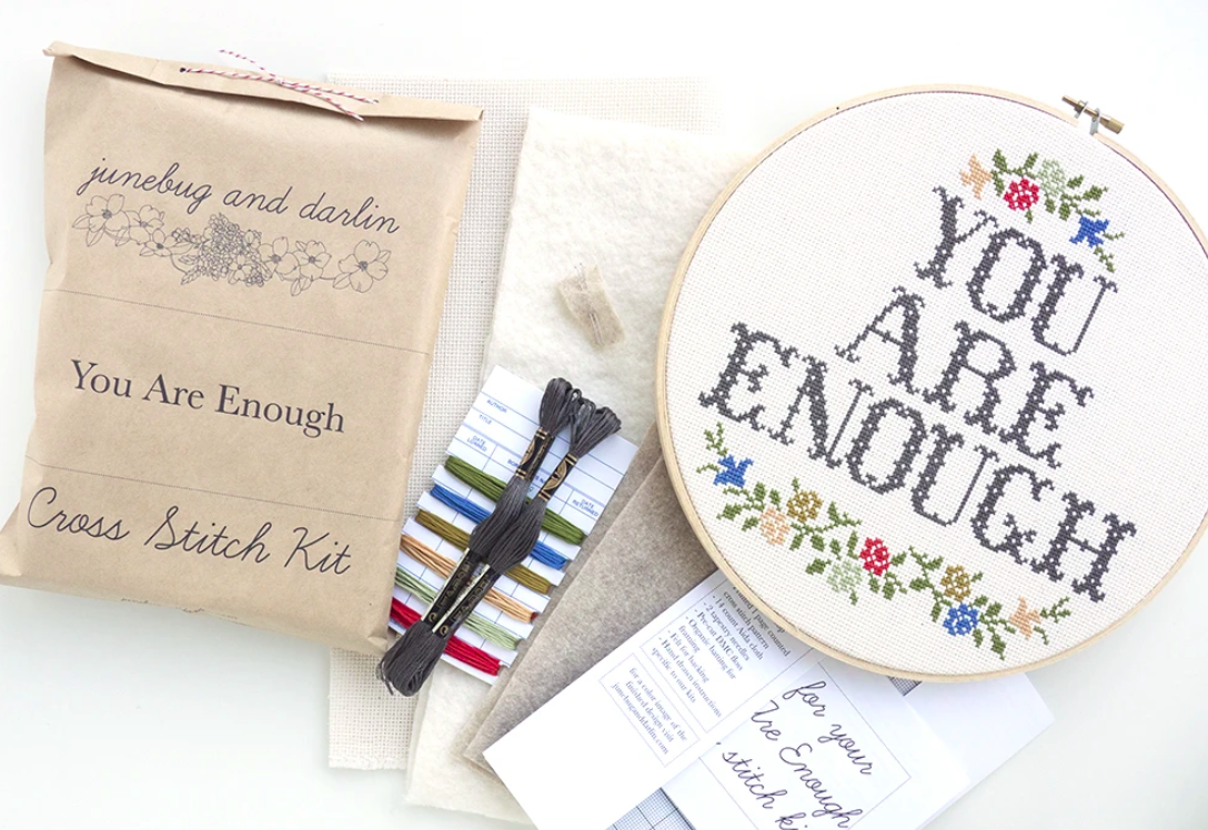 A cross-stitch kit with the text "you are enough" on it