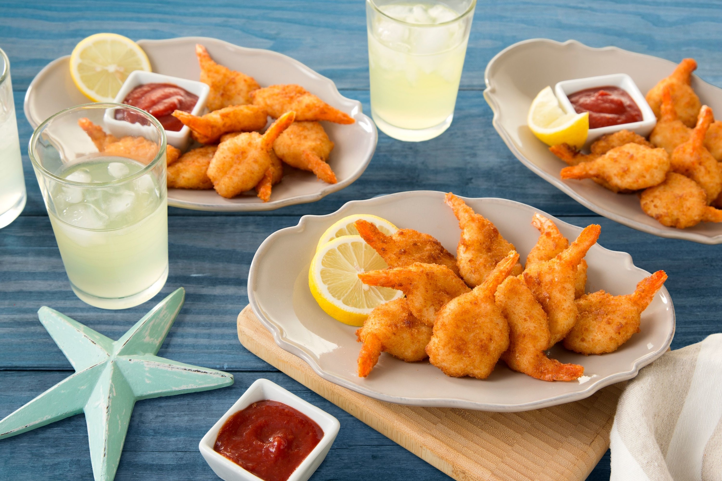 Plates of cooked, breaded shrimp