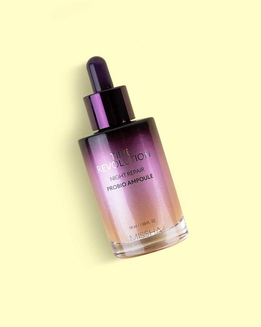 the night repair serum bottle that starts out as black and fades into purple and then orange