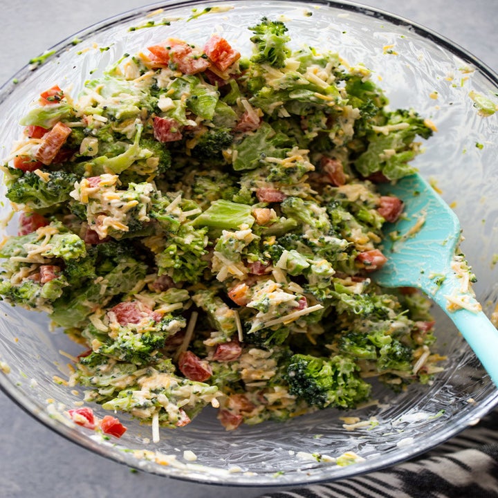 A bowl of broccoli filling with garlic, bell pepper, parmesan, cheddar, and cream cheese.