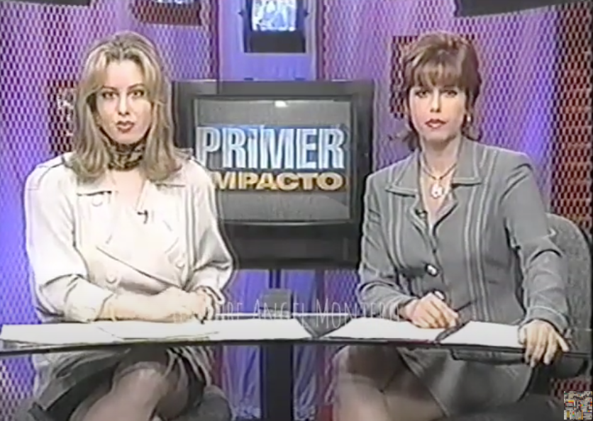 Two hosts sitting at the desk of Primer Impacto