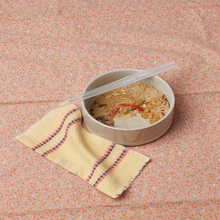 one of the small bowls filled with ramen on a floral table cloth