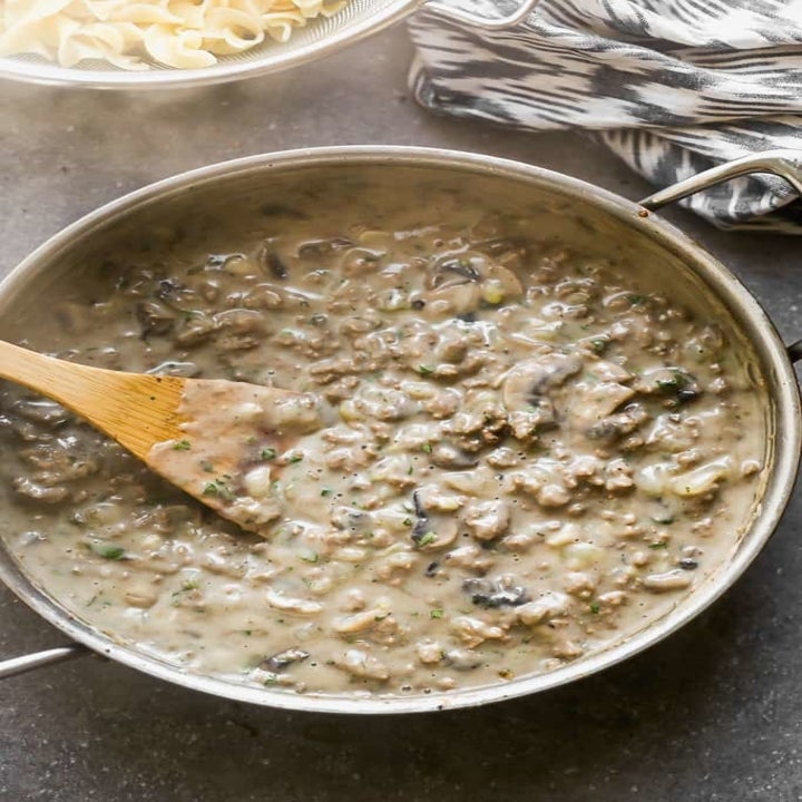 A bowl of beef stroganoff gravy, made with mushrooms, cream of mushroom soup, and ground beef.
