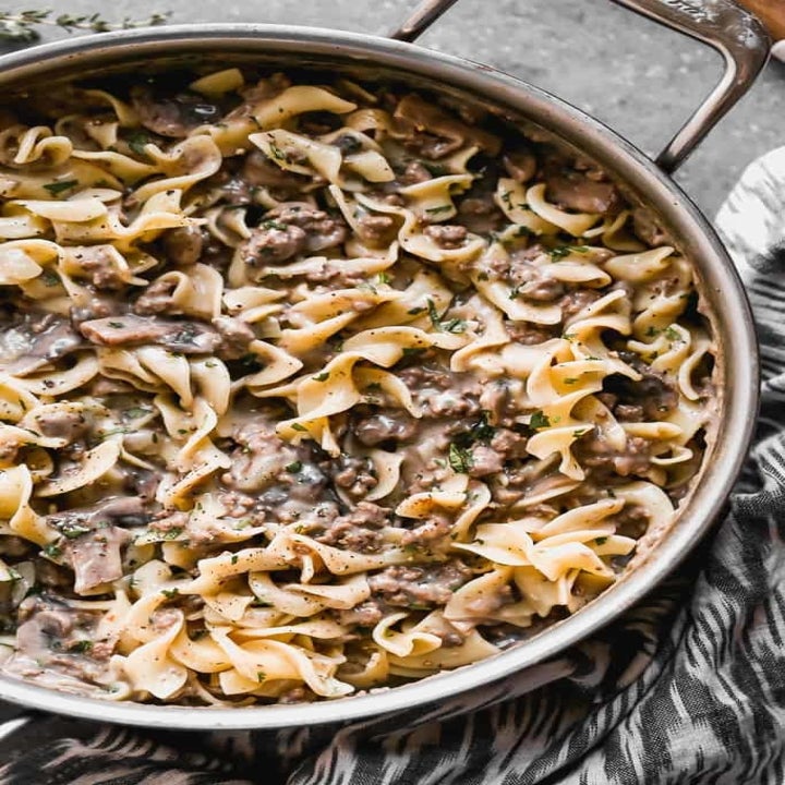 A skillet of egg noodles and creamy beef stroganoff.
