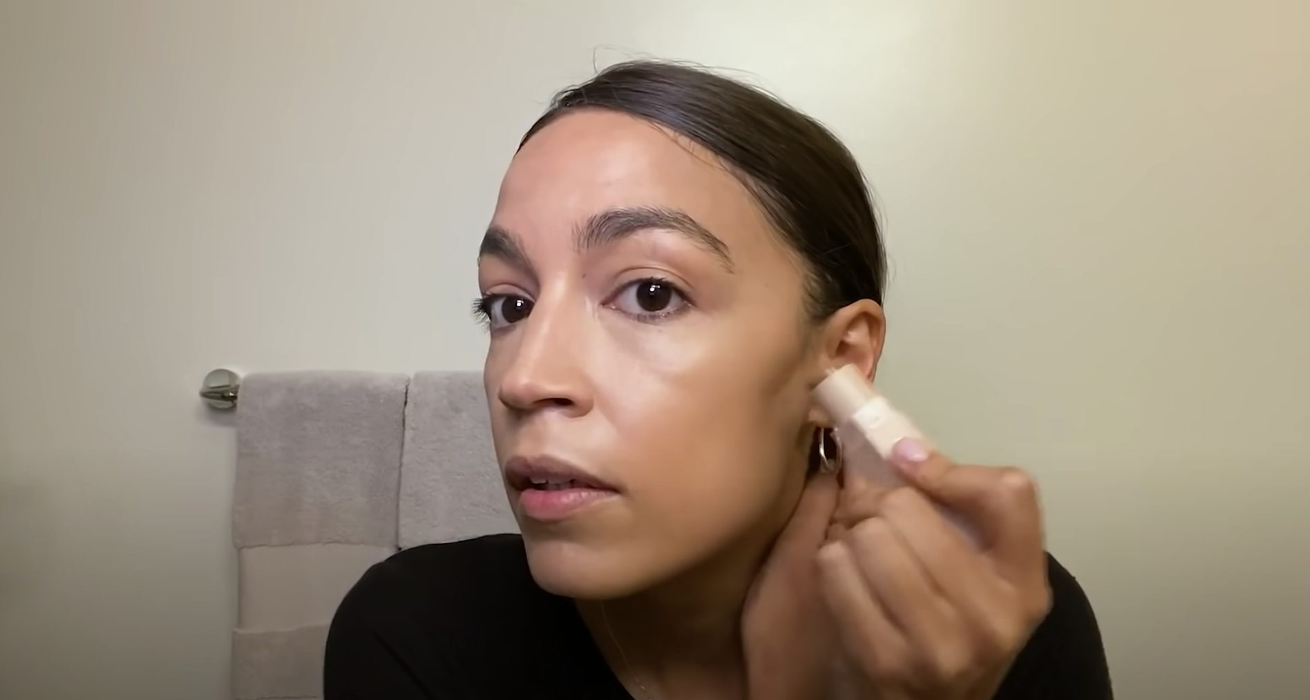 Alexandria Ocasio-Cortez using a contour stick.