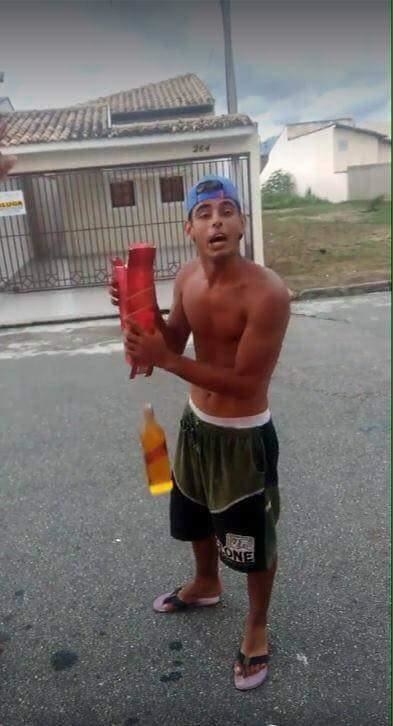 a man is holding a liquor bottle that is falling from his hands
