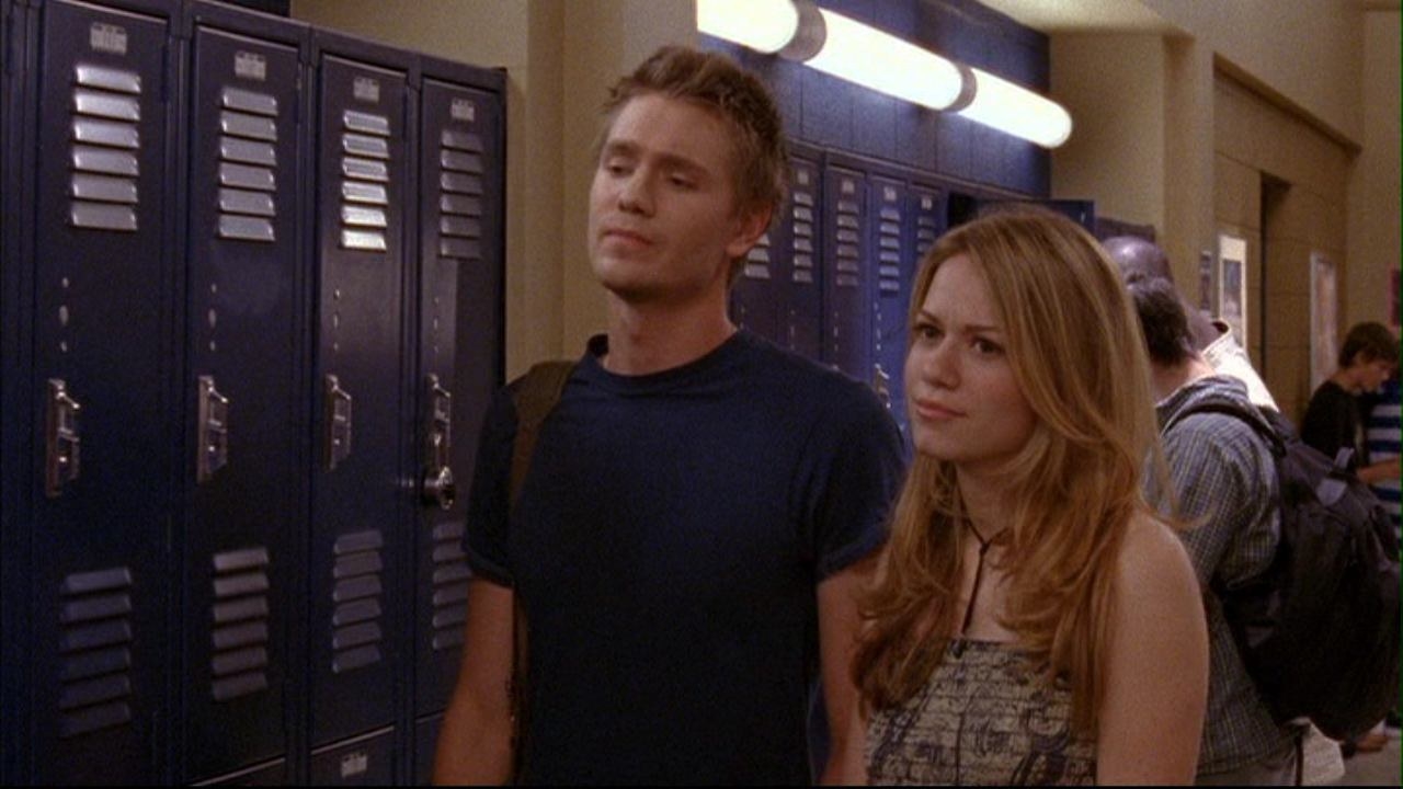 Lucas and Haley walking the school hallway together