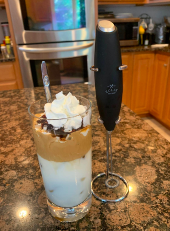 Reviewer uses black milk frother to make Dalgona coffee in their kitchen