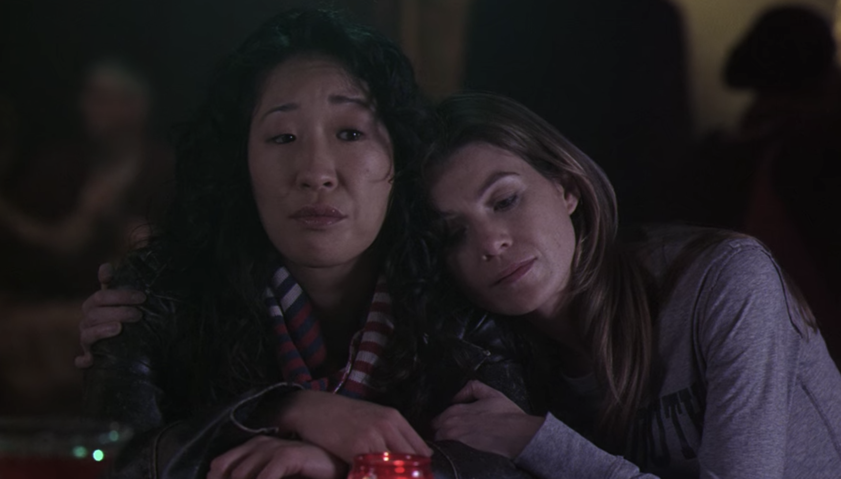 Cristina and Meredith hugging in a bar