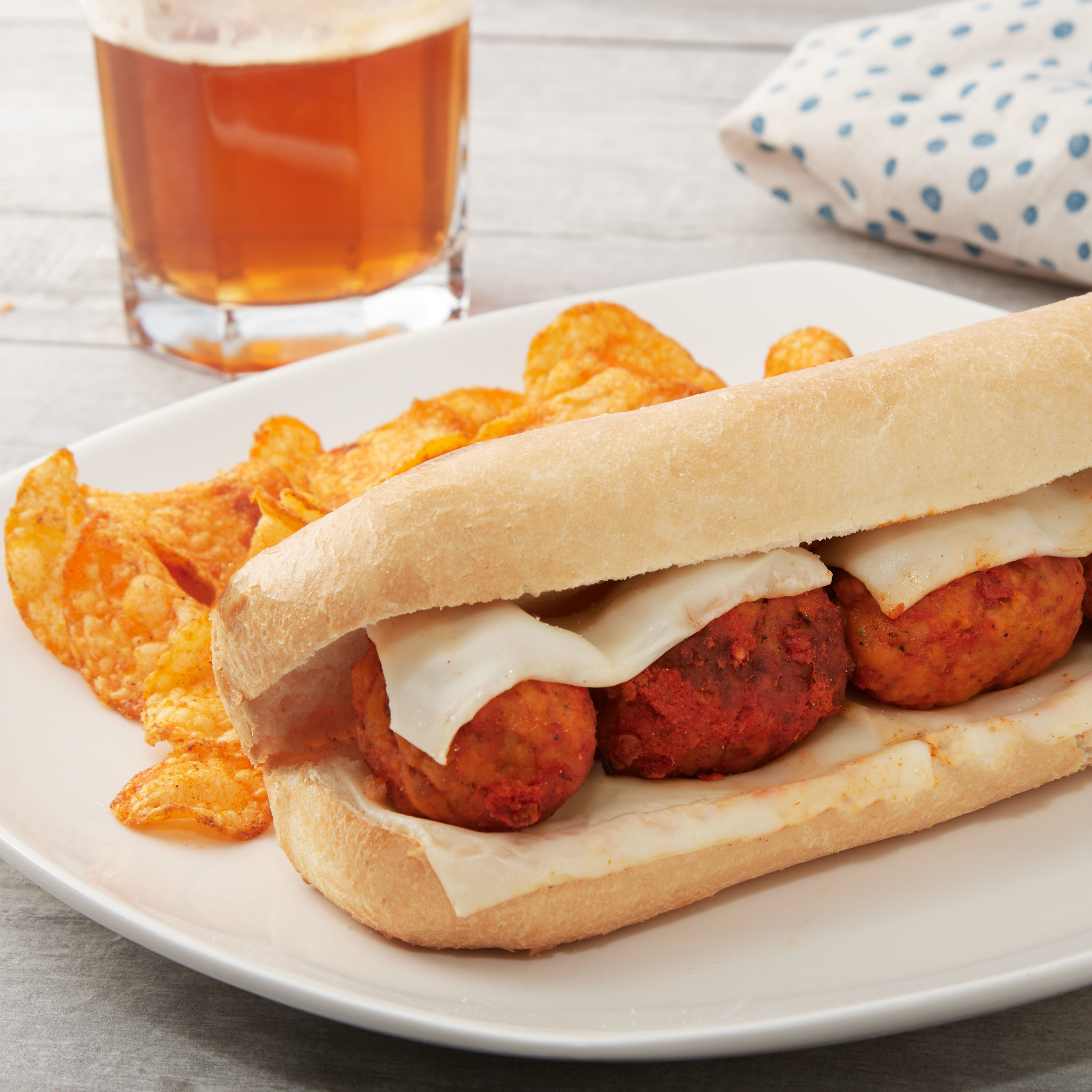The meatball sandwich with cheese on a plate