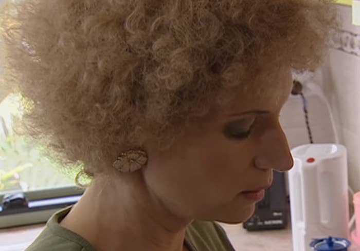 Kath wearing giant gilded flower studs